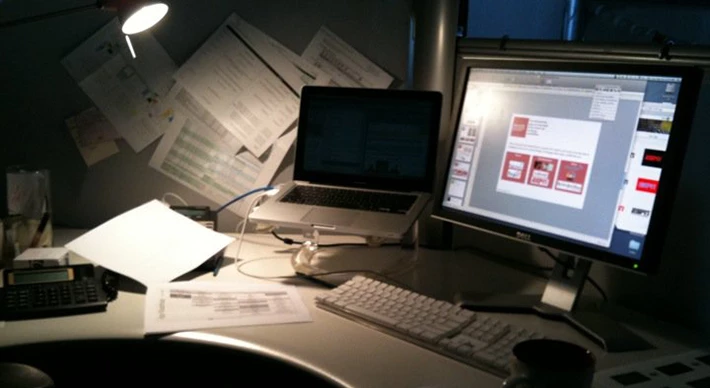 A computer screen working on a presentation in a dimly lit office.